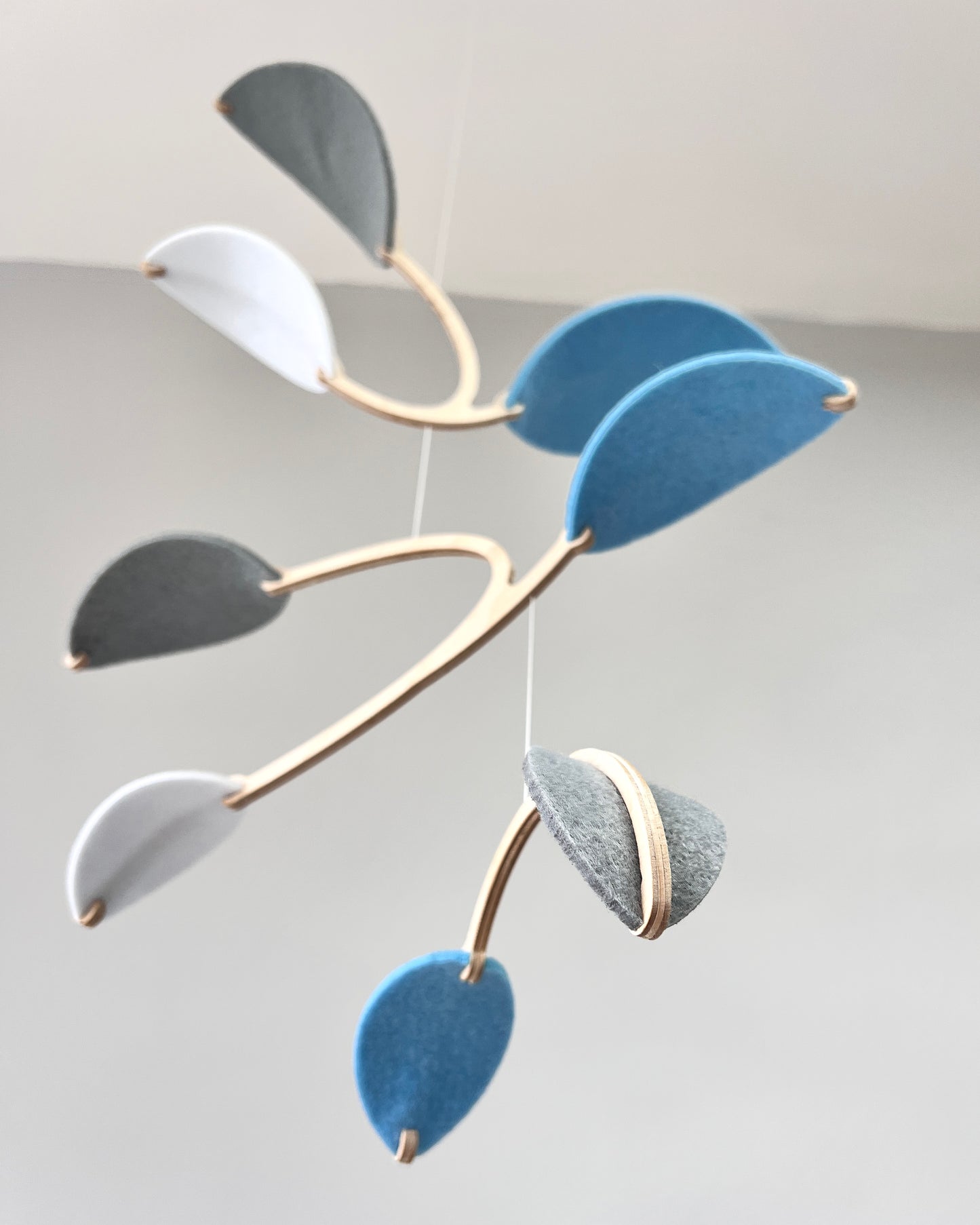 Leaf Mobile 

Felt & Wood Leaf Mobile, Adult or Baby Mobile Gift Idea, Plant inspired Sculpture, Kinetic Art Mobile. Pale Blue, White and Grey

This vibrant felt leaf mobile is a charming addition to your home decor, offering a lightweight and artistic touch. Handmade with colorful felt leaf shapes, it features independently rotating wooden stems crafted from birch wood, arranged in a customizable color order that can be adjusted anytime.