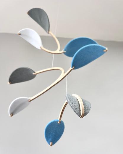 Leaf Mobile 

Felt & Wood Leaf Mobile, Adult or Baby Mobile Gift Idea, Plant inspired Sculpture, Kinetic Art Mobile. Pale Blue, White and Grey

This vibrant felt leaf mobile is a charming addition to your home decor, offering a lightweight and artistic touch. Handmade with colorful felt leaf shapes, it features independently rotating wooden stems crafted from birch wood, arranged in a customizable color order that can be adjusted anytime.