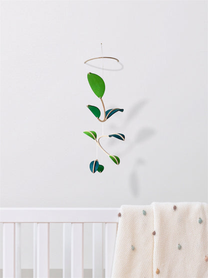 Wall Hanging Plant Mobile, Kinetic Artificial Plant Wall Art for Planted living Space, Leafy Office & Nature Nursery decor. Alternative Gift

Felt Leaf Mobile can be used as a ceiling hanging mobile or as a wall hanging plant mobile. 

Elevate your space with this versatile Midcentury Modern Mobile, designed for both nurseries and adult living areas. Crafted from natural wood with deep teal and green shades of soft felt, this handmade nursery mobile embodies a minimalist and Scandinavian aesthetic.