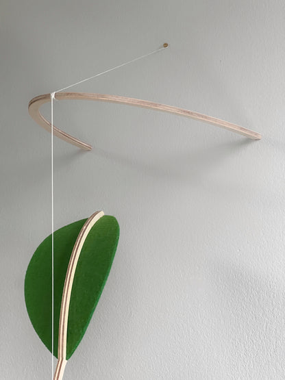 Wall Hanging Plant Mobile, Kinetic Artificial Plant Wall Art for Planted living Space, Leafy Office & Nature Nursery decor. Alternative Gift

Felt Leaf Mobile can be used as a ceiling hanging mobile or as a wall hanging plant mobile. 

Elevate your space with this versatile Midcentury Modern Mobile, designed for both nurseries and adult living areas. Crafted from natural wood with deep teal and green shades of soft felt, this handmade nursery mobile embodies a minimalist and Scandinavian aesthetic.