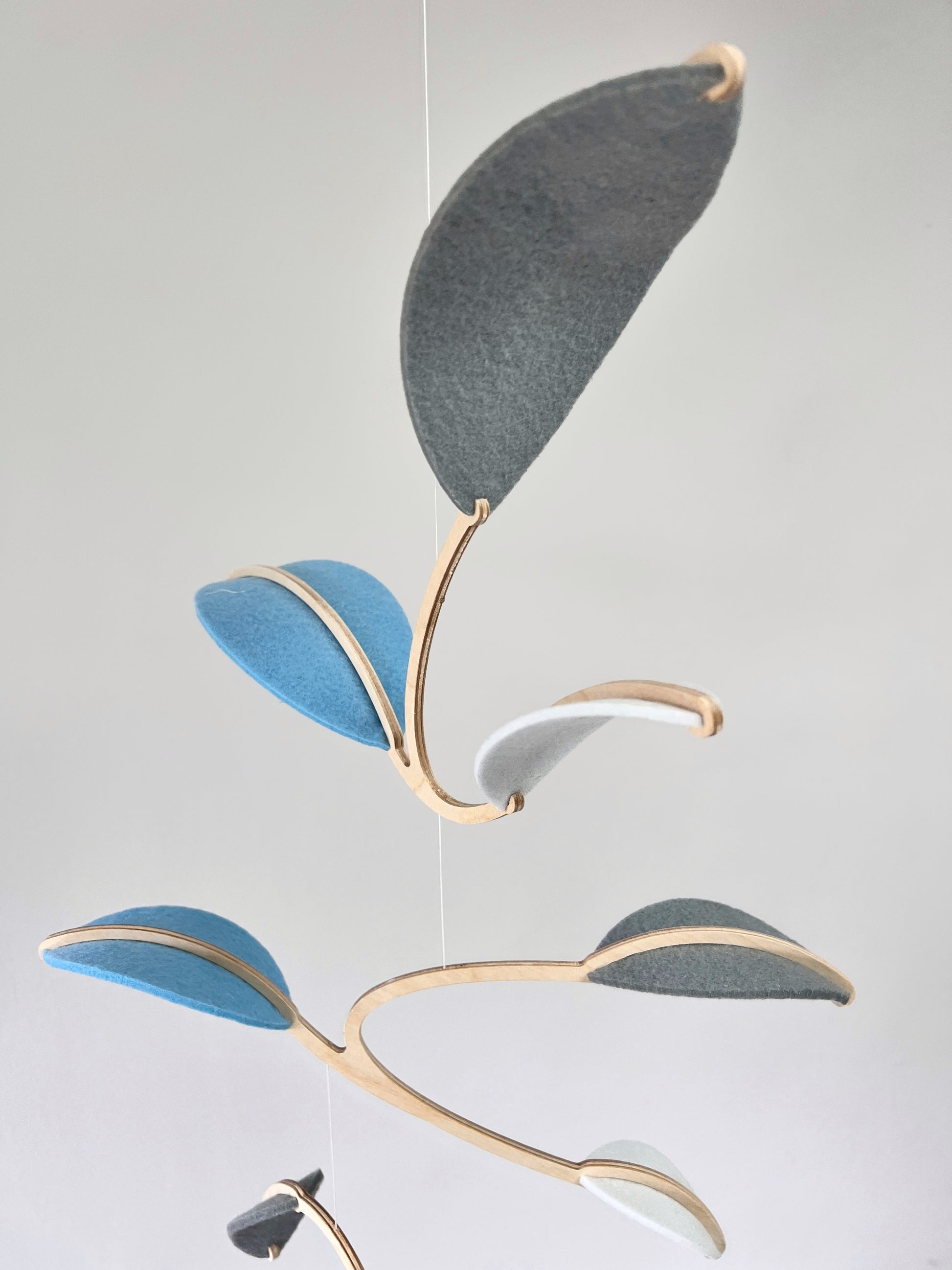 Leaf Mobile 

Felt & Wood Leaf Mobile, Adult or Baby Mobile Gift Idea, Plant inspired Sculpture, Kinetic Art Mobile. Pale Blue, White and Grey

This vibrant felt leaf mobile is a charming addition to your home decor, offering a lightweight and artistic touch. Handmade with colorful felt leaf shapes, it features independently rotating wooden stems crafted from birch wood, arranged in a customizable color order that can be adjusted anytime.