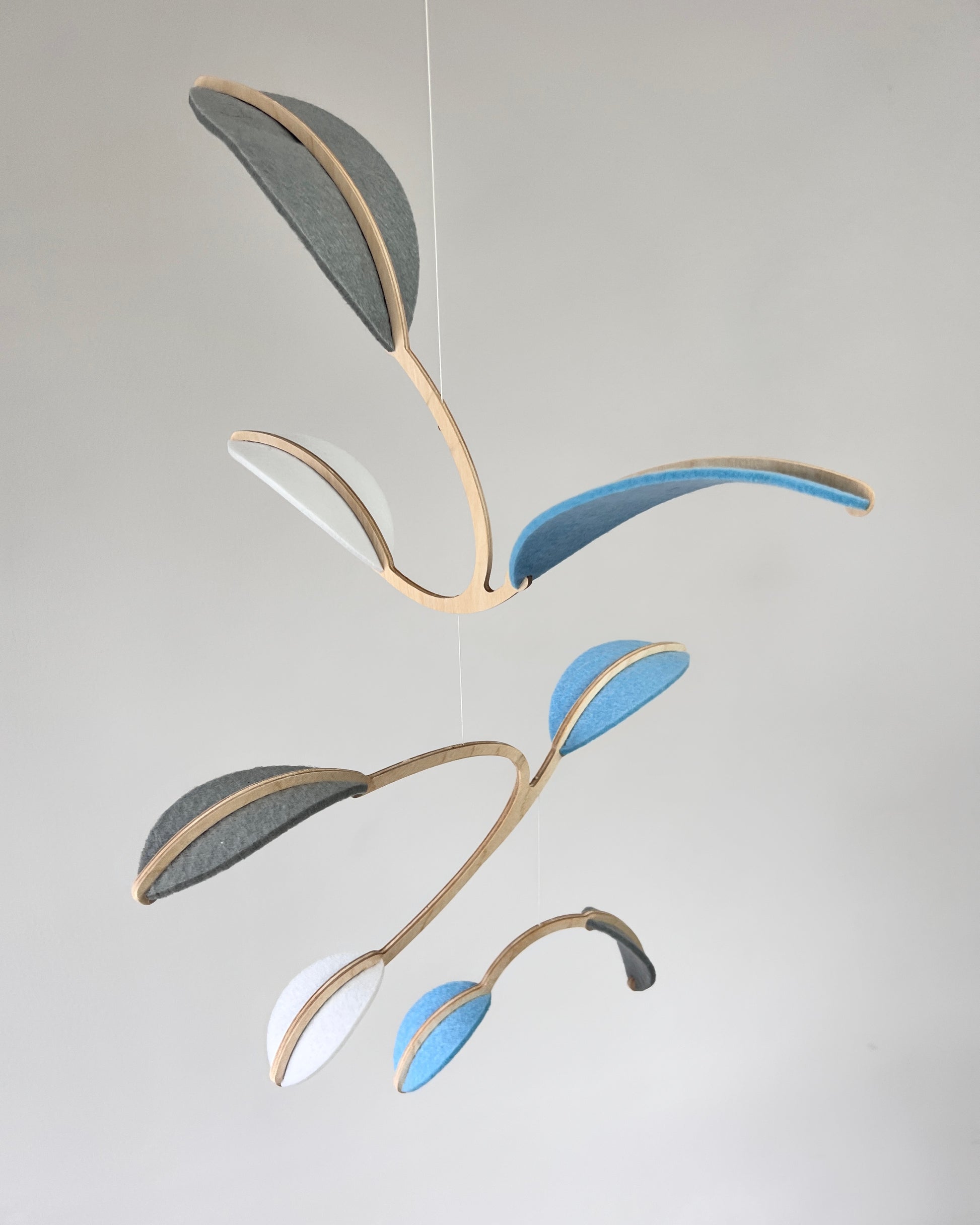 Leaf Mobile 

Felt & Wood Leaf Mobile, Adult or Baby Mobile Gift Idea, Plant inspired Sculpture, Kinetic Art Mobile. Pale Blue, White and Grey

This vibrant felt leaf mobile is a charming addition to your home decor, offering a lightweight and artistic touch. Handmade with colorful felt leaf shapes, it features independently rotating wooden stems crafted from birch wood, arranged in a customizable color order that can be adjusted anytime.