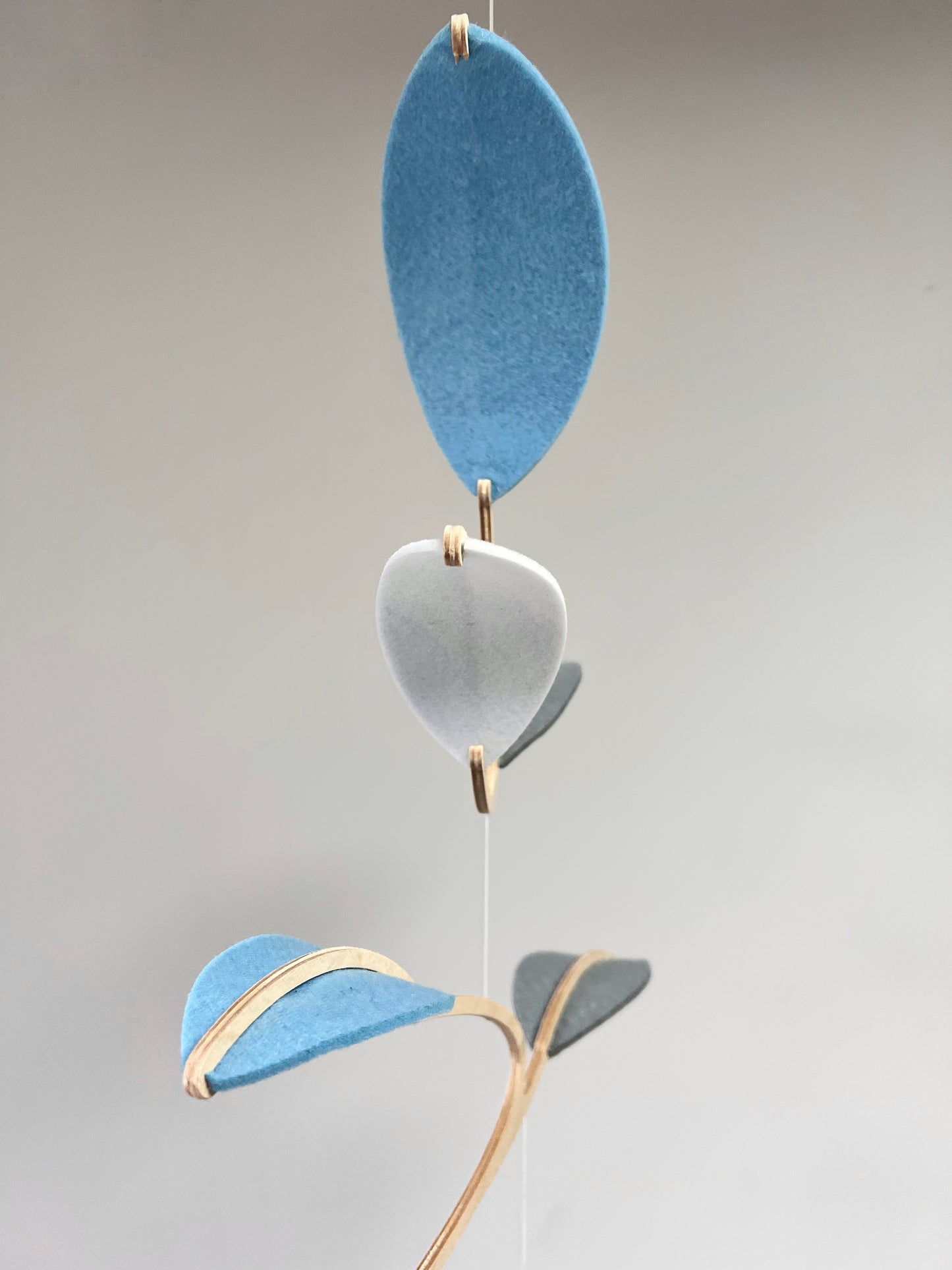 Leaf Mobile 

Felt & Wood Leaf Mobile, Adult or Baby Mobile Gift Idea, Plant inspired Sculpture, Kinetic Art Mobile. Pale Blue, White and Grey

This vibrant felt leaf mobile is a charming addition to your home decor, offering a lightweight and artistic touch. Handmade with colorful felt leaf shapes, it features independently rotating wooden stems crafted from birch wood, arranged in a customizable color order that can be adjusted anytime.